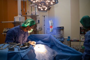 smart medical technology concept, doctor use augmented reality to show the injury of spine bone of the patient while surgery in operating room in hospital. it help to make clearly decision,precision